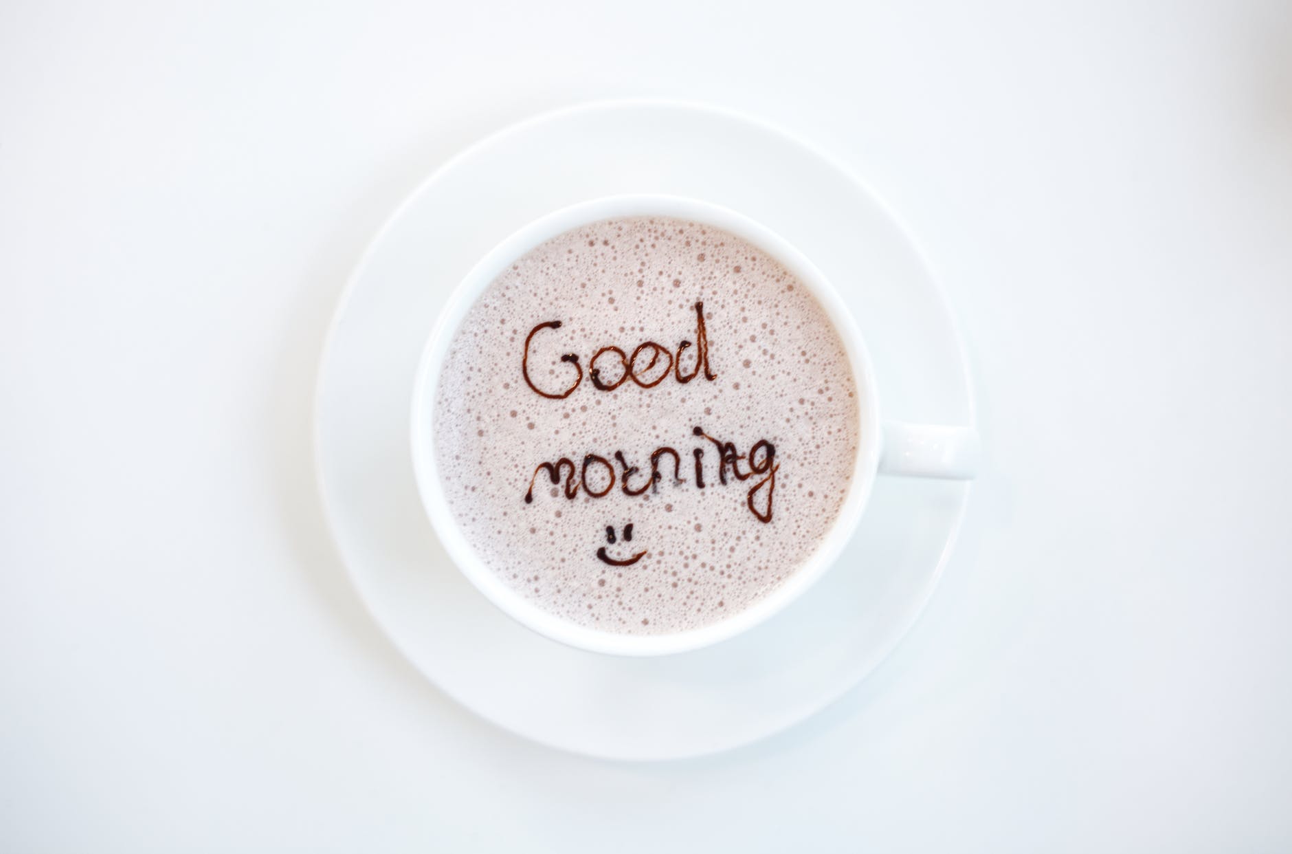 white cup filled by coffee